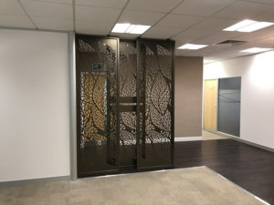 Decorative reception screens in doctors entrance hall with company logo