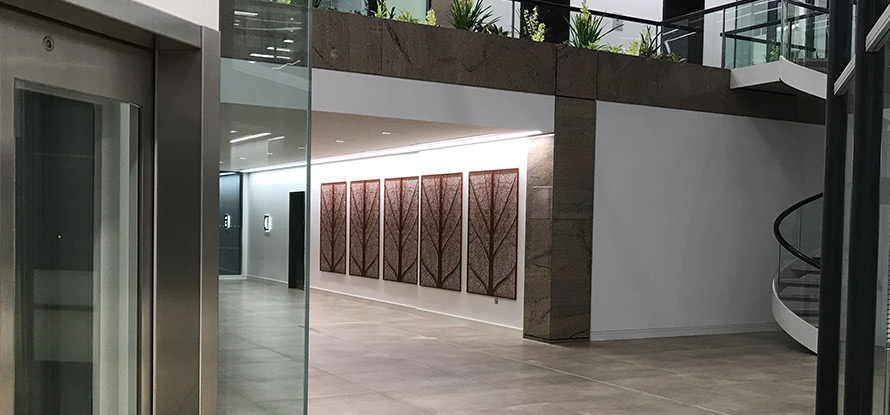 Laser cut wall art panels in commercial entrance hall