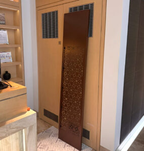 Before shot showing decorative air conditioning laser cut screens One Hyde Park to cover doors in hotel spa